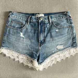 Free People distressed denim shorts with lace detail bottom